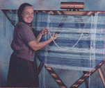 This image from our Workshop Video " Triangle Frame Loom Weaving Magic for Shawls, Blankets,Jackets and More " shows Carol Leigh weaving on a Spriggs Adjustable Triangle Frame Loom. Click here to go to the Tri-Loom Video page.